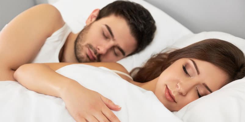 couple in bed sleeping next to each other