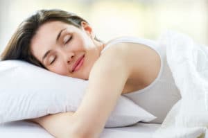 woman really enjoying hugging a pillow