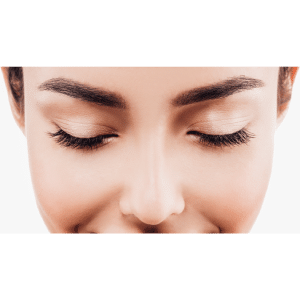 close up of woman's face looking down with eyes close and solid white background