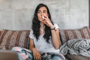young-woman-sick-at-home-spraying-nasal-spray