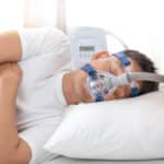 senior man wearing Cpap mask sleeping